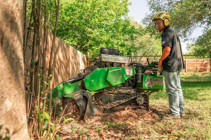 Stump grinder in operation on a rural property