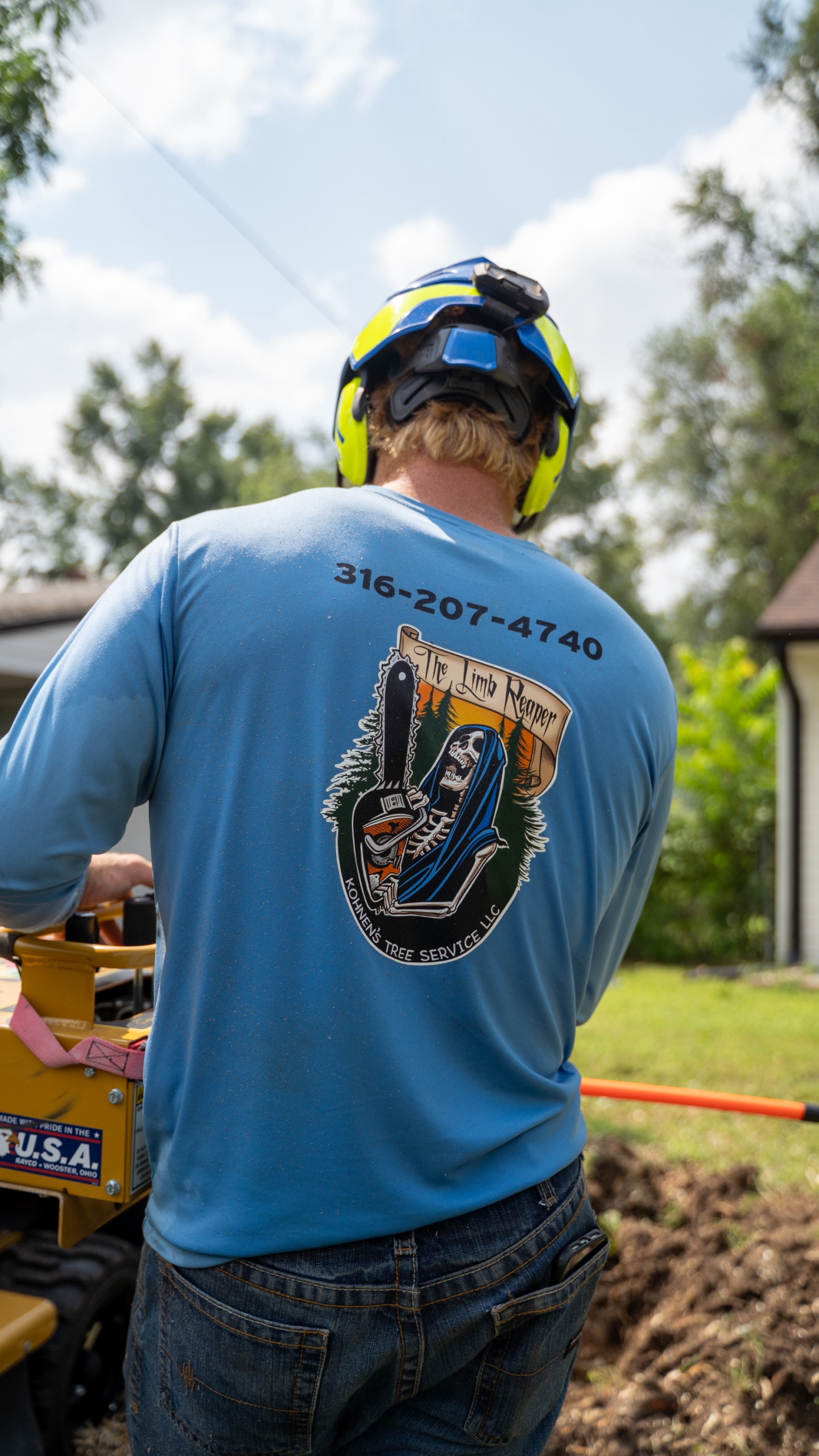 Professional stump grinding machine removing a large tree stump in a Wichita Kansas backyard